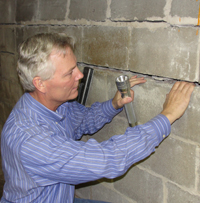 Dale inspecting wall